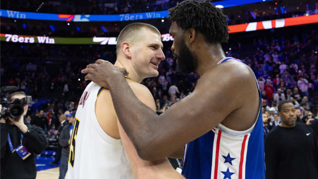 Jan 16, 2024; Philadelphia, Pennsylvania, USA; Philadelphia 76ers center Joel Embiid (21) hugs and talks with Denver Nuggets center Nikola Jokic (15) after the game at Wells Fargo Center. Mandatory Credit: Bill Streicher-USA TODAY Sports  